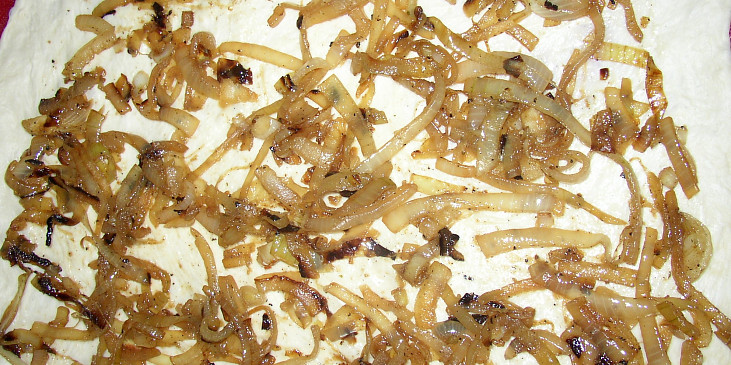 Slaninové vdolečky s cibulí a sýrem (rozválený plát těsta potřený cibulí)