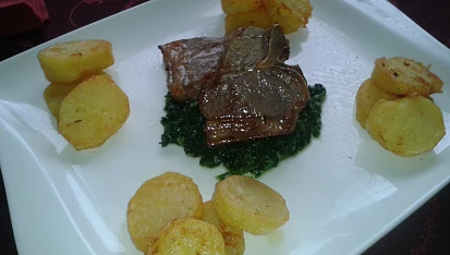 Jehněčí T-bone steak, na špenátovém lůžku s česnekem a restovanými brambory s tymiánem