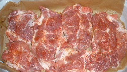 Římovské maso pod sýrovou poklicí, pod masem osmažená cibule, maso naklepané, poprášené paprikou