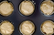 Připravíme si formu na muffiny, do které dáme košíčky na muffiny. Na dno košíčku dáme trošku těsta. Doprostřed těsta dáme trochu nasekané čokolády nebo čokoládových čoček. Na čokoládu dáme další vrstvu těsta. Košíček by měl být naplněný cca do 3/4.